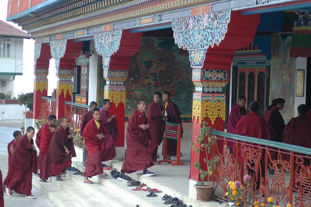 Monks entering a temple seen during the Red Panda Expedition in Northeastern India