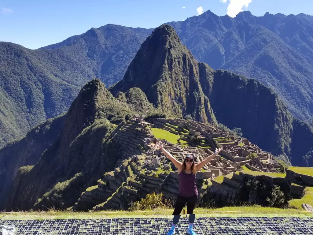 Traveller posing in front of Machu Pichu on the Peru Explorer Vacation