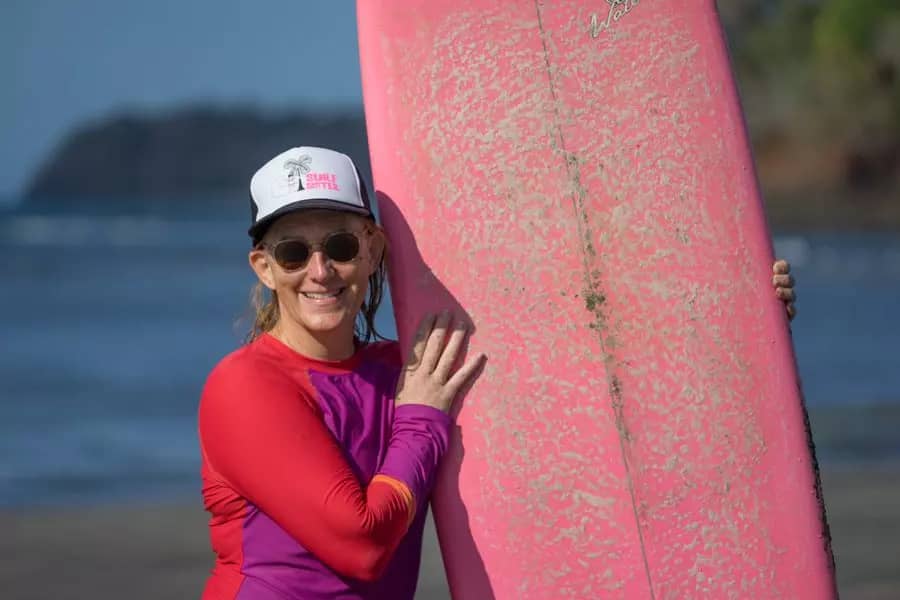 Sherry Otto holding a surfboard